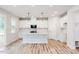 Open-concept kitchen features an island with a sink and ample cabinet space for storage at 427 Fast Pitch Ln, Four Oaks, NC 27524