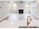 Open-concept living room with a fireplace, large windows, and modern flooring at 427 Fast Pitch Ln, Four Oaks, NC 27524