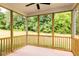 Relaxing screened porch offers views of the spacious backyard and lush green trees at 427 Fast Pitch Ln, Four Oaks, NC 27524