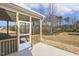 An inviting screened-in back porch with a concrete patio, perfect for outdoor relaxation and entertaining at 52 Gander Dr, Benson, NC 27504