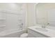 Clean, well-lit bathroom featuring a white vanity, shower-tub combo, and white tile at 52 Gander Dr, Benson, NC 27504