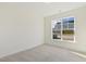 Bright, carpeted bedroom features a large window and neutral walls, creating a calm space at 52 Gander Dr, Benson, NC 27504