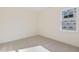 Bedroom with neutral carpet, white walls, and a window allowing natural light at 52 Gander Dr, Benson, NC 27504