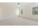 Bright bedroom with tray ceiling, ceiling fan, and large windows at 52 Gander Dr, Benson, NC 27504