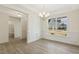 Bright dining area with stylish chandelier, wainscoting, and a view of the community, offers inviting ambiance at 52 Gander Dr, Benson, NC 27504
