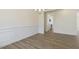 Elegant dining room features wainscoting, wood-look floors, and a view into the kitchen for seamless entertaining at 52 Gander Dr, Benson, NC 27504