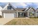 Beautiful single Gathering home featuring stone accents, gray siding, two-car garage and manicured front lawn at 52 Gander Dr, Benson, NC 27504