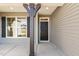 Covered front porch with gray columns, a black front door, and a large window at 52 Gander Dr, Benson, NC 27504