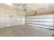 Clean, unfinished garage with concrete floor and white garage door ready to customize at 52 Gander Dr, Benson, NC 27504