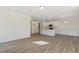 Spacious kitchen featuring white cabinets, an island and wood-style flooring at 52 Gander Dr, Benson, NC 27504