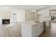 Modern kitchen showcasing a center island, stainless steel appliances, and an open living area at 52 Gander Dr, Benson, NC 27504