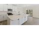 Bright kitchen with stainless steel appliances, quartz countertops, and a breakfast bar, ideal for meal preparation at 52 Gander Dr, Benson, NC 27504