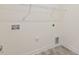 A bright unfinished laundry room with utility connections and a wire rack shelf at 52 Gander Dr, Benson, NC 27504