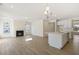 Open-concept living room featuring a fireplace and kitchen island with light wood-style flooring at 52 Gander Dr, Benson, NC 27504