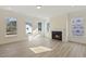Bright living room featuring large windows and a cozy fireplace at 52 Gander Dr, Benson, NC 27504