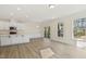 Bright and airy living room featuring a white kitchen, recessed lighting and sliding door to the exterior at 52 Gander Dr, Benson, NC 27504