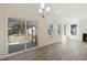 Bright living room featuring hardwood floors, large windows, and a screened porch at 52 Gander Dr, Benson, NC 27504