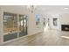 Bright living room featuring large windows, a sliding door to exterior and a fireplace at 52 Gander Dr, Benson, NC 27504