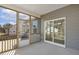 Well-lit screened porch with view of nearby houses and sliding door access at 52 Gander Dr, Benson, NC 27504