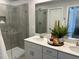 Modern bathroom featuring tiled walk-in shower, double vanity, and quartz counters at 565 Marthas View Way, Wake Forest, NC 27587