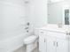Well-lit bathroom featuring a shower and tub combo and white vanity at 565 Marthas View Way, Wake Forest, NC 27587