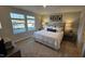 Inviting bedroom with large windows, a plush bed, and stylish decor at 565 Marthas View Way, Wake Forest, NC 27587