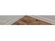 Close-up showcasing a durable wood-look floor, installed over white trim at 565 Marthas View Way, Wake Forest, NC 27587