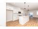 Modern kitchen featuring white cabinets, stainless steel appliances, and a spacious island with seating at 565 Marthas View Way, Wake Forest, NC 27587