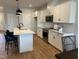 Spacious kitchen featuring white cabinets, modern appliances, and an island with pendant lighting at 565 Marthas View Way, Wake Forest, NC 27587