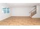 Bright living room with wood-look floors, a staircase, and large window allowing ample natural light at 565 Marthas View Way, Wake Forest, NC 27587