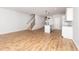 Spacious living room adjacent to the kitchen area, featuring wood-look floors, stairs, and neutral wall color at 565 Marthas View Way, Wake Forest, NC 27587