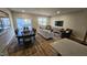 Open concept living and dining area with modern furniture and bright lighting at 565 Marthas View Way, Wake Forest, NC 27587