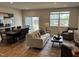 Open-concept living area with wood floors, a sliding door, and neutral-toned furnishings at 565 Marthas View Way, Wake Forest, NC 27587