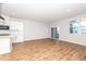 Bright and airy living room with wood-look floors, large windows, and sliding glass doors leading to outdoor area at 565 Marthas View Way, Wake Forest, NC 27587
