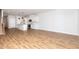 Open-concept living space featuring wood-look floors, kitchen, staircase, and plenty of natural light at 565 Marthas View Way, Wake Forest, NC 27587