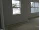 Bedroom featuring pristine white walls, trim, and two windows at 2909 Frances Marie Ln, Raleigh, NC 27603