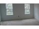 Empty bedroom featuring two windows that let in natural light at 2909 Frances Marie Ln, Raleigh, NC 27603