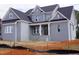 Newly constructed two-story home featuring gray brick, a covered porch, and a dark roof at 2909 Frances Marie Ln, Raleigh, NC 27603