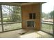 Screened porch with wood ceiling, floor, fireplace and view of yard at 2909 Frances Marie Ln, Raleigh, NC 27603