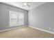 Well-lit bedroom with carpet, neutral walls and ceiling fan at 609 E Harnett St, Lillington, NC 27546