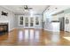 Open floor plan living room with hardwood floors, fireplace, and kitchen views at 609 E Harnett St, Lillington, NC 27546