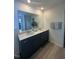 Bathroom featuring double sinks, a large mirror, and contemporary fixtures at 2728 Princess Tree Dr, Raleigh, NC 27616