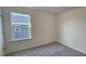 Bright bedroom with a large window providing natural light and plush carpeting at 2728 Princess Tree Dr, Raleigh, NC 27616