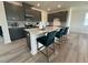 Kitchen island features bar seating, stainless steel appliances, and modern grey cabinets at 2728 Princess Tree Dr, Raleigh, NC 27616
