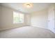 Light-filled bedroom with carpet, a window, and a closet door at 196 Abingdon Farms Dr, Selma, NC 27576