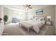 Staged primary bedroom featuring tray ceiling, neutral decor, and a seating area at 196 Abingdon Farms Dr, Selma, NC 27576
