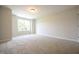Inviting bedroom with plush carpet and a bright window for natural light at 196 Abingdon Farms Dr, Selma, NC 27576