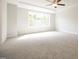 Spacious bedroom featuring carpeted floors, tray ceilings and a large window at 196 Abingdon Farms Dr, Selma, NC 27576