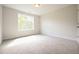 Bright, carpeted bedroom with a large window letting in natural light at 196 Abingdon Farms Dr, Selma, NC 27576
