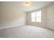 Well-lit bedroom with carpeted floors and a window offering outdoor views at 196 Abingdon Farms Dr, Selma, NC 27576